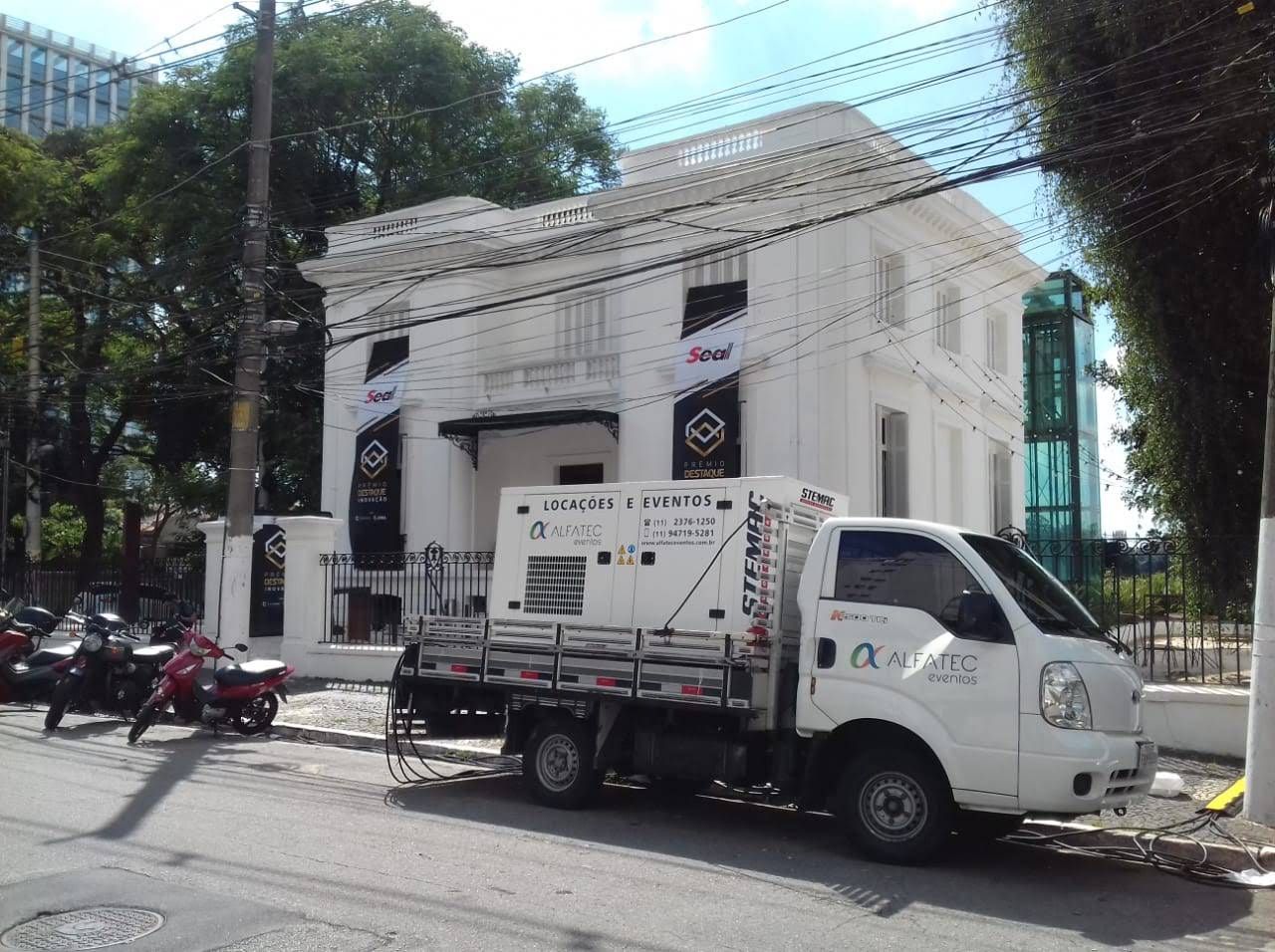 Caminhão Alfatec com gerador em frente a casarão histórico usado como espaço de eventos